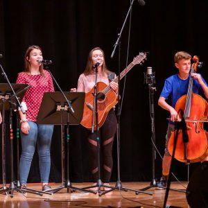 MAT Campers performing - vocalist, cello, and guitar