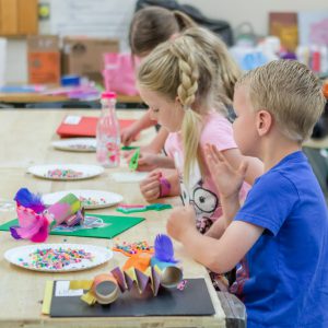 Young MAT Campers learning a new craft