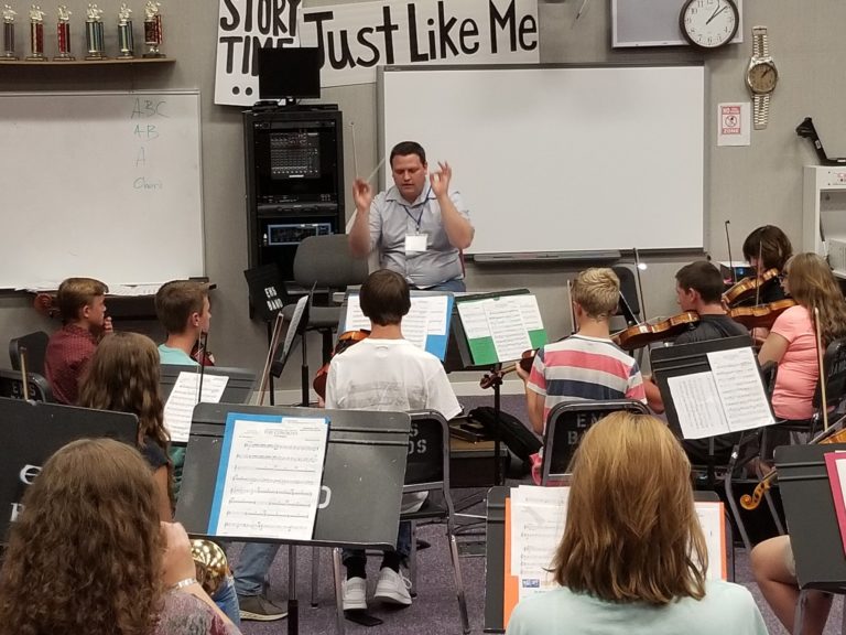 Mat Camp faculty member teaching string instruments