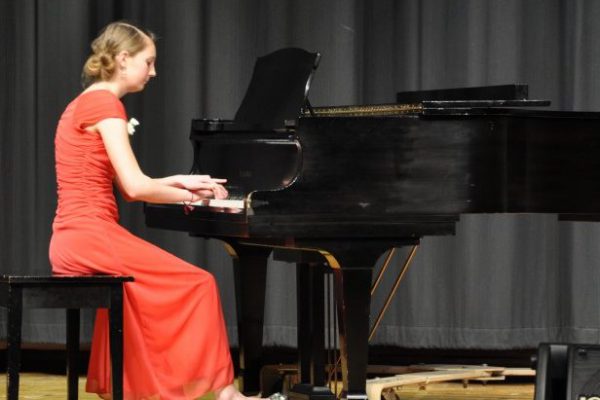 A young woman playing the piano in the Honors Concert at a Bowen Young Musicians Festival